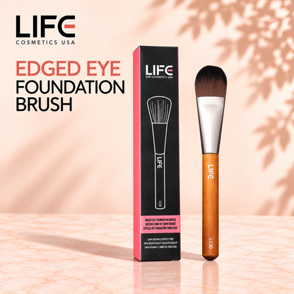 LIFE Cosmetics USA LC30 Edged Eye Foundation Brush with a wooden handle beside its black and pink retail box.