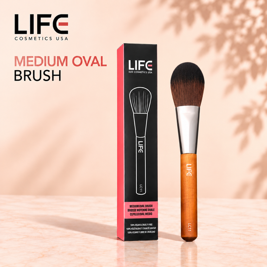 LIFE Cosmetics USA LC11 Medium Oval Brush with a wooden handle beside its black and pink retail box.