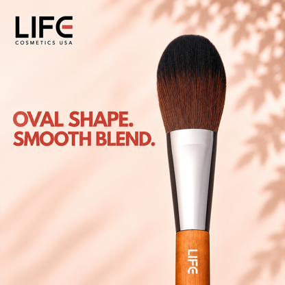 Close-up of the LIFE Cosmetics USA LC11 Medium Oval Brush showing oval bristles, a silver ferrule and wooden handle.