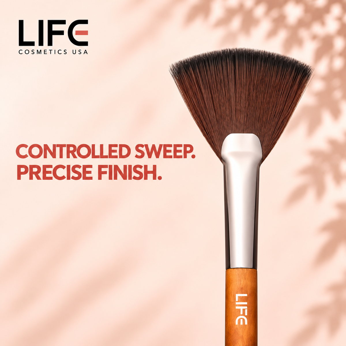 Close-up of the LIFE Cosmetics USA LC16 Controlled Fan Brush showing fan-shaped bristles, a silver ferrule and wooden handle.