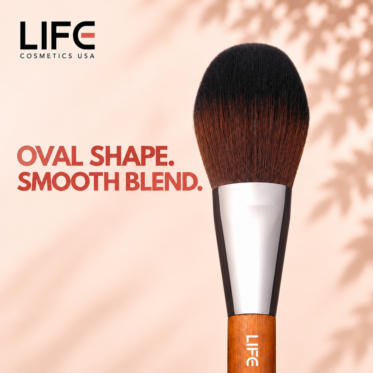 Close-up of the LIFE Cosmetics USA LC10 Large Oval Brush showing oval bristles, a silver ferrule and wooden handle.