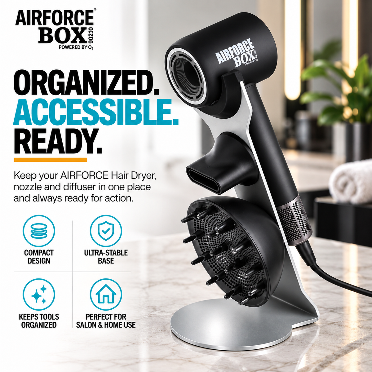 Silver BOX90210 AIRFORCE docking stand holding a black hair dryer, concentrator nozzle and diffuser on a bathroom counter.