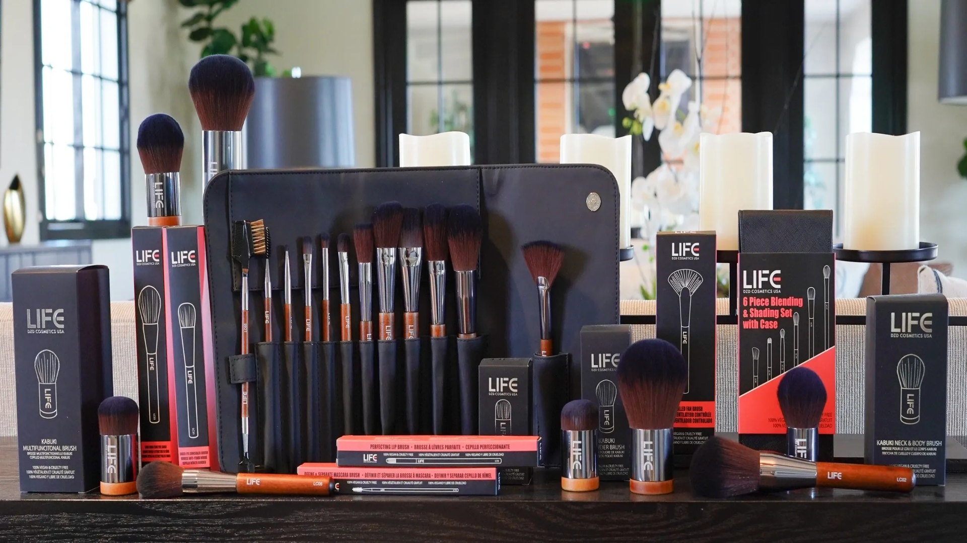 Collection of makeup brushes and packaging on a table with a blurred background