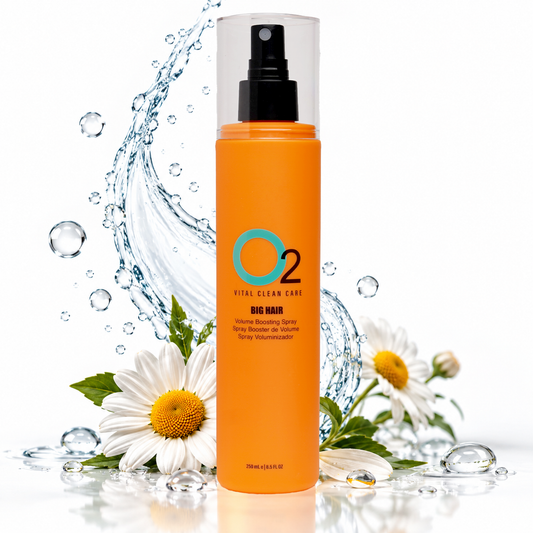 O2 BIG HAIR volume boosting spray in an orange 250 mL bottle, surrounded by white flowers and a water splash.