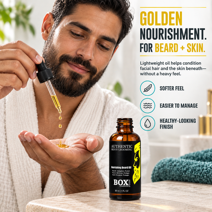 Bearded man in a white bathrobe dispensing golden oil from a dropper into his palm beside an open BOX90210 Nourishing Beard Oil bottle, with softness, manageability and finish callouts.