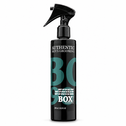 Black BOX90210 Surf’s Up Sea Salt Spray bottle with a trigger sprayer and teal and white lettering, labeled 250 ml / 8.5 fl oz, shown on white.