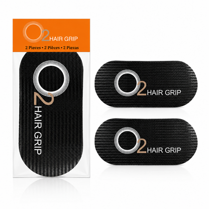 O2 Hair Grip two-piece package with an orange header beside two black textured hair grips with rounded corners and O2 logos.