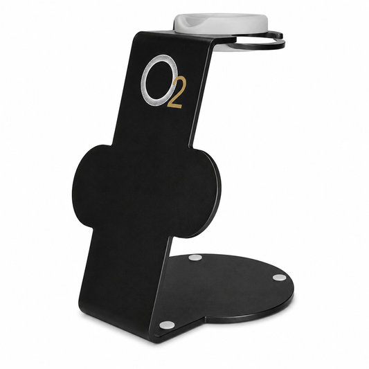 Black O2 Professional hair dryer stand with a white top cradle, two circular attachment holders, and a rounded base on white.