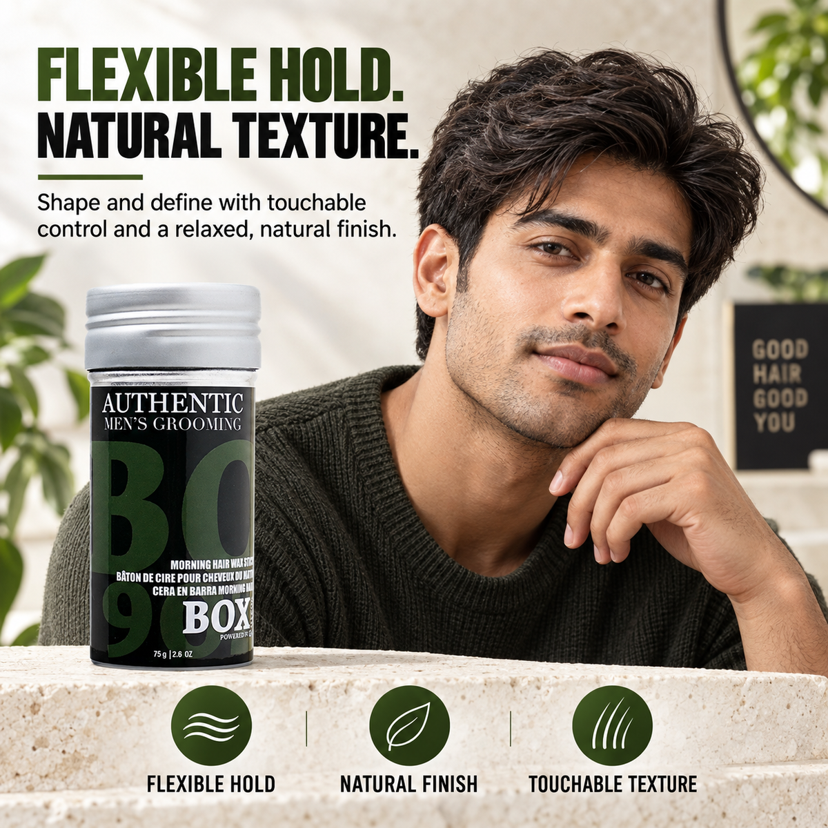 Man with tousled dark hair beside a BOX90210 Morning Hair Wax Stick on a light stone counter, with flexible-hold, natural-finish and touchable-texture callouts.