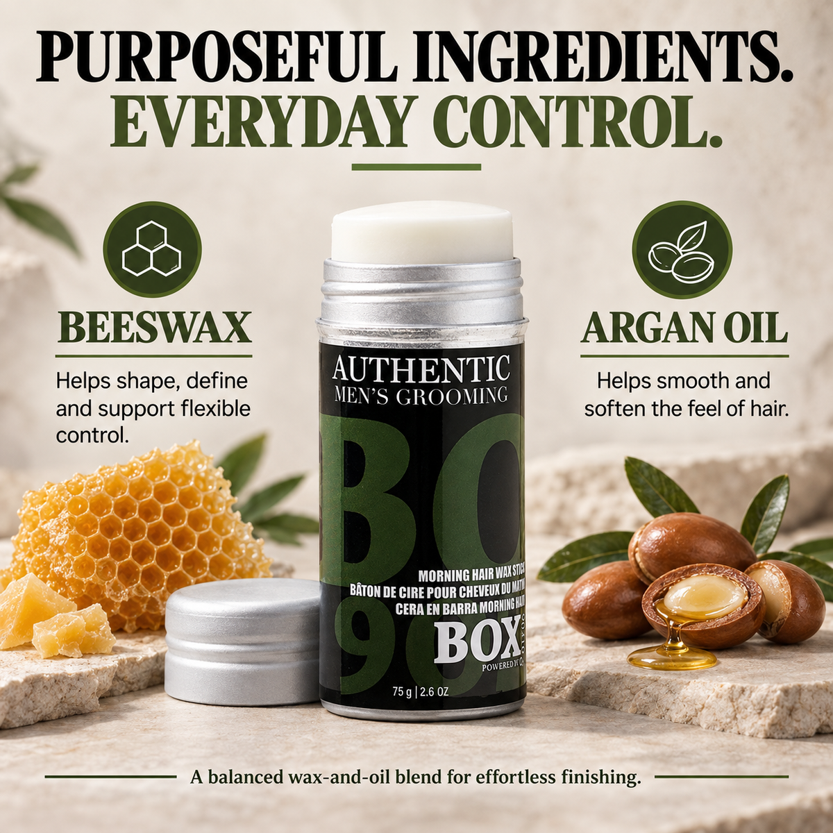 Uncapped BOX90210 Morning Hair Wax Stick beside its cap, honeycomb and argan nuts with oil, with beeswax and argan oil callouts.
