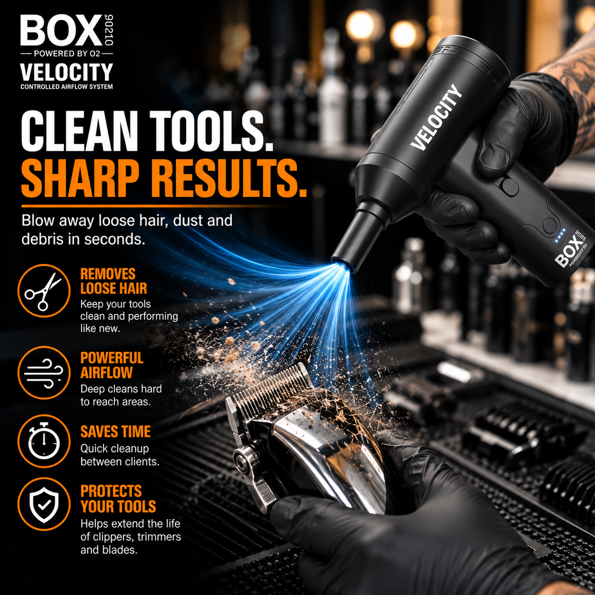 Gloved hands using BOX90210 VELOCITY with a narrow nozzle to blow loose hair and debris from clipper blades in a barbershop.