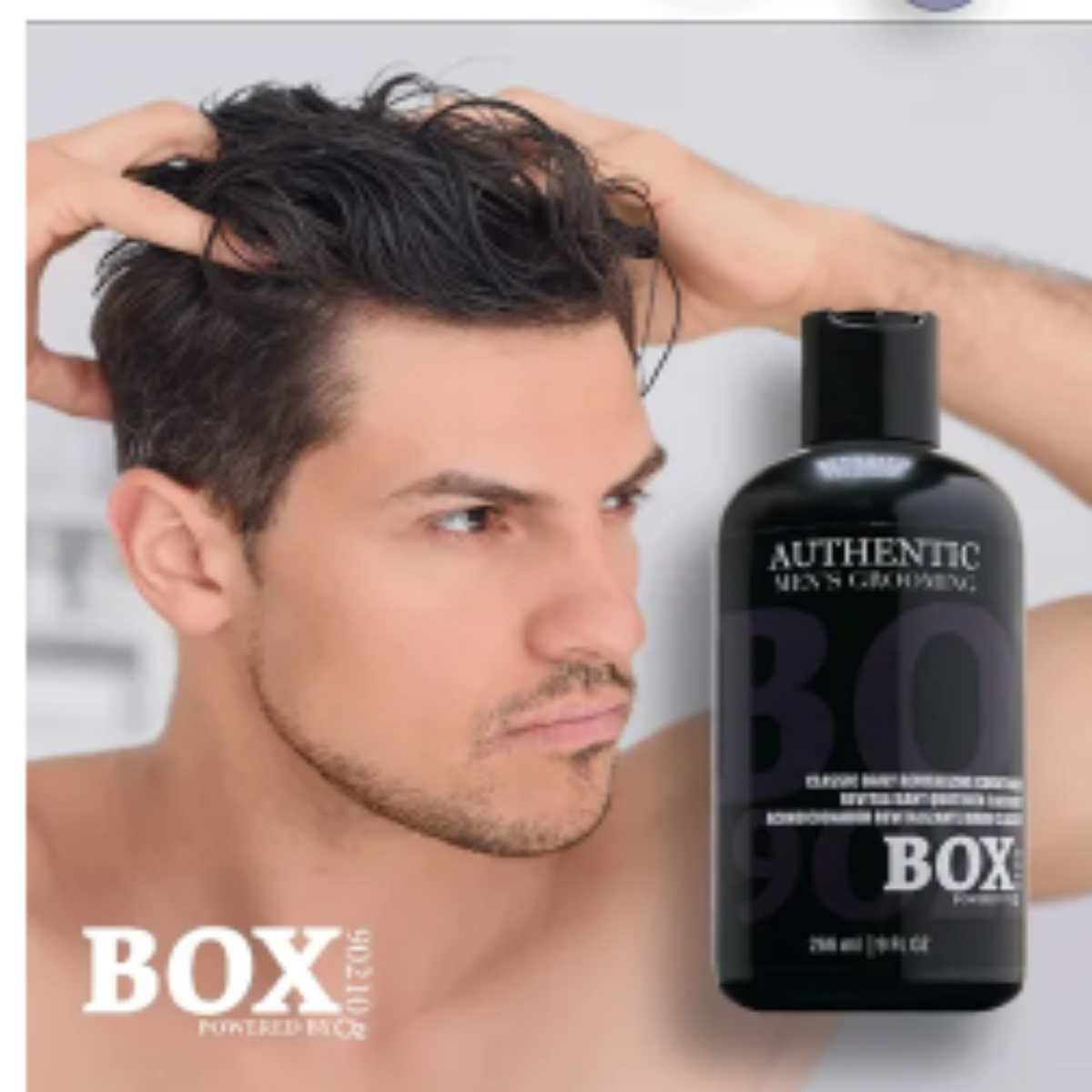 Man with styled hair holding a bottle of 'BOX' hair product.