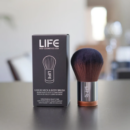 Kabuki neck and body brush with packaging on a blurred background