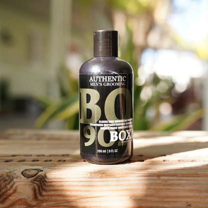 Bottle of BO 90 Box on a wooden surface with a blurred outdoor background