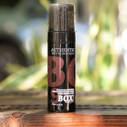 Men's grooming product on a wooden surface with a blurred natural background