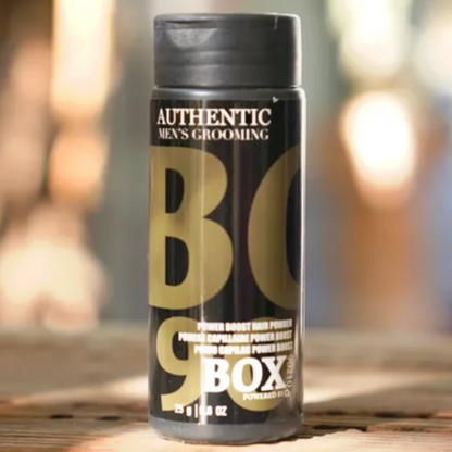 BOXX grooming product on a wooden surface with a blurred outdoor background