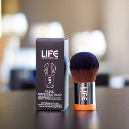 LIFE kabuki brush and packaging on a blurred background