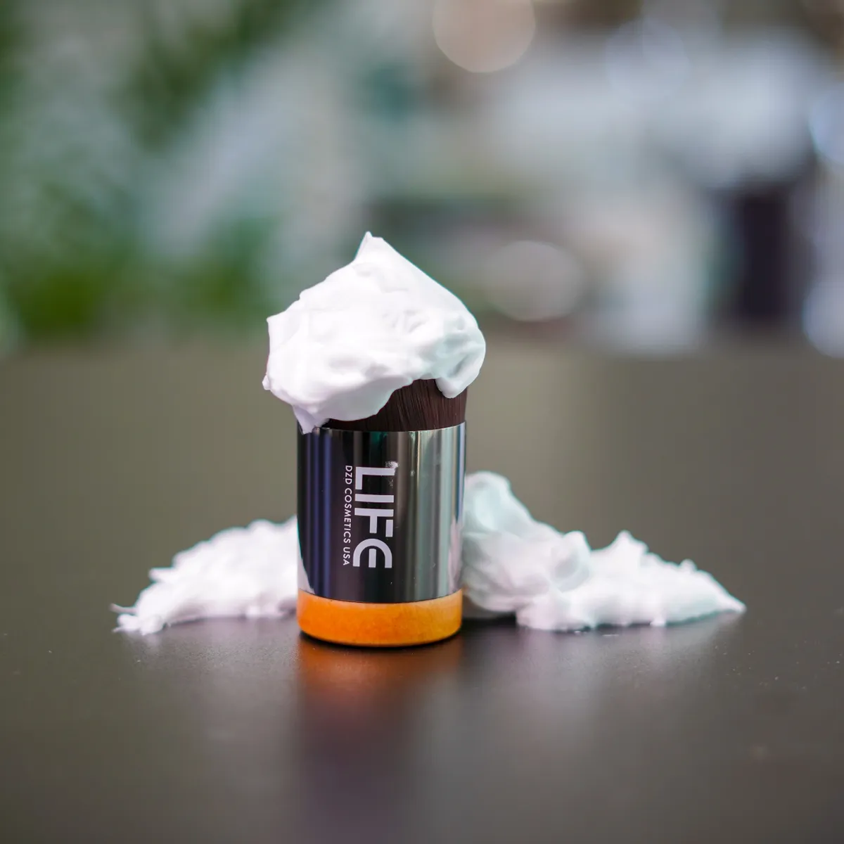 LIFE product with whipped cream on a dark surface