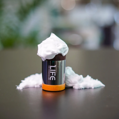 LIFE product with whipped cream on a dark surface